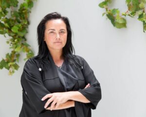 Kiri Nathan stands with her arms crossed in a leather jacket, ahead of her NZFW show