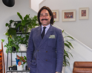 Robert Niwa Stands in a double-breasted suit, originally published in Metro.